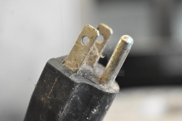 Close-up of a worn plug for a WF-A2000 Juicer, showing signs of corrosion and dirt. 110 Volts, 1 Phase.