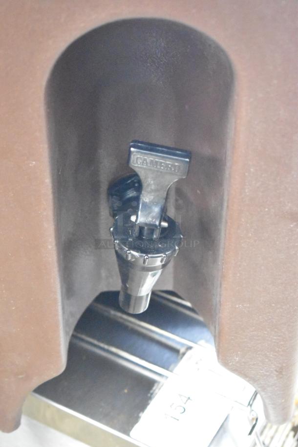 2 Cambro brown poly beverage dispensers, spigot visible, good condition, includes marking "Cambro" on handle.