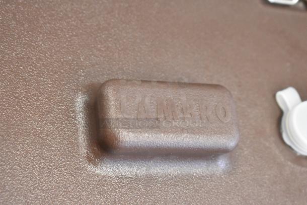 2 Cambro brown poly beverage dispensers, embossed with "CAMBRO," durable, ideal for catering, lightly used.