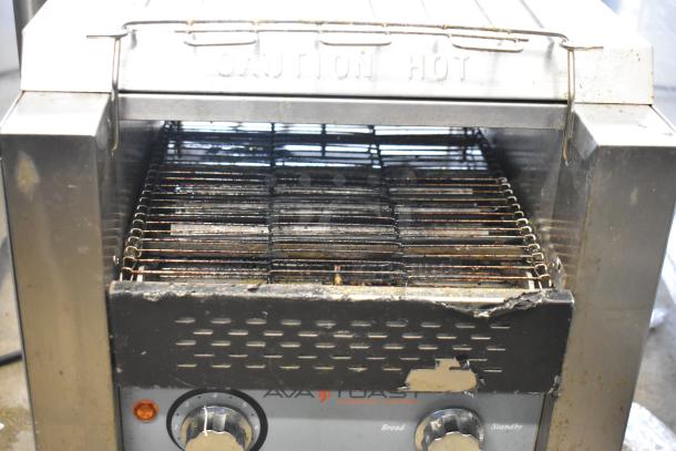 AvaToast 184T140 Commercial Conveyor Toaster Oven, 120V, visible wear, "Caution Hot" marking, dual knobs for control.