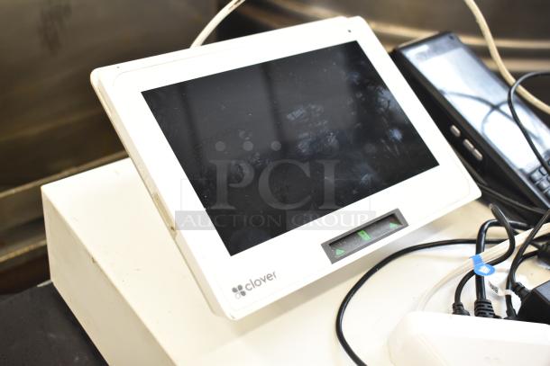 Clover POS System with C305 Mini Monitor, credit card reader, and cash drawer. Slight wear on screen; cords visible.