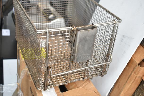 Stainless steel pressure fryer basket, used, visible wear, part of a 5-item auction including VitaMix blender pitchers.