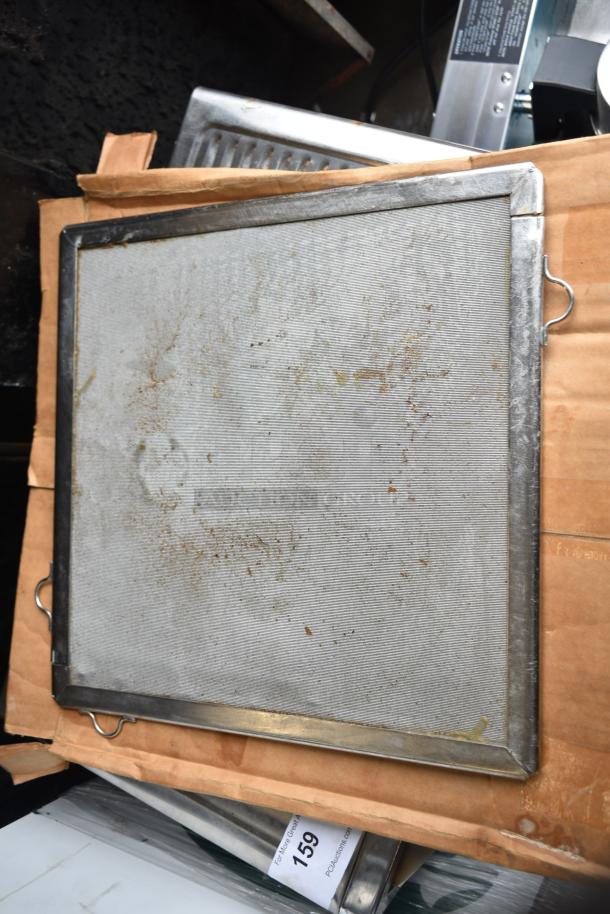 Metal fryer basket with slightly worn surface on top of packaging. Auction lot tag "159" visible.