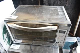 Oster TSSTTVDGXL countertop toaster oven, stainless steel, digital controls, visible wear, 120V, 1 Phase, auction tag visible.