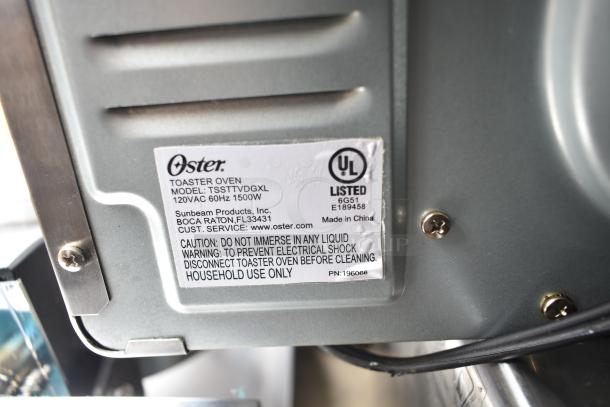 Oster TSSTTVDGXL toaster oven label, showing model, 120V, 60Hz, 1500W specs, and UL certification on metal casing.