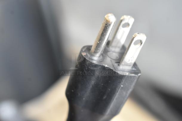 Vapor Systems VX5000 heating element plug, 120V, 1 phase, model VX5000. Black casing, metal prongs, slight wear visible.