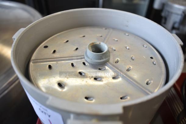 Robot Coupe R2N food processor with grating blade. Visible model label and sturdy metal construction. 120 volts, 1 phase.