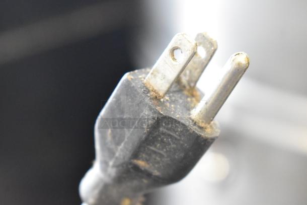 Robot Coupe R2N food processor plug, 120 volts, showing wear. Perfect for commercial kitchen use.