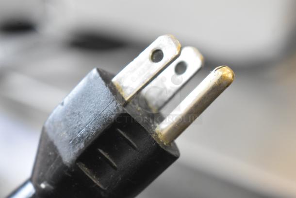 Close-up of a power plug for a Robot Coupe R2UB countertop food processor base, 120 volts, 1 phase.