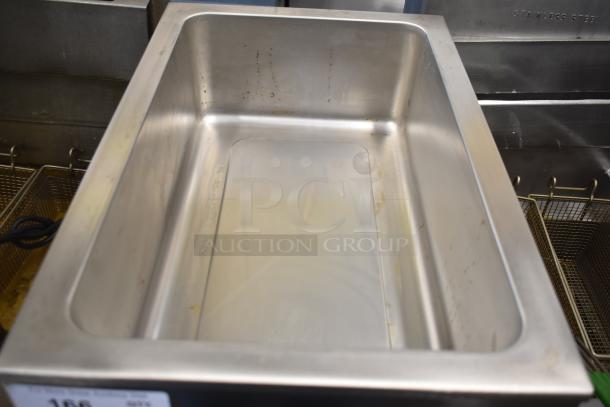 Winco FW-S500 Countertop Food Warmer in stainless steel. 120 Volts, 1 Phase. Shows some wear and light staining inside.
