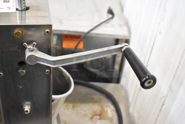 Uniworld countertop sausage stuffer with manual crank, stainless steel finish, visible safety and use label, good condition.