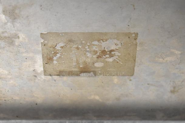 Uniworld Countertop Sausage Stuffer, worn condition with a faded label, indicating significant use.