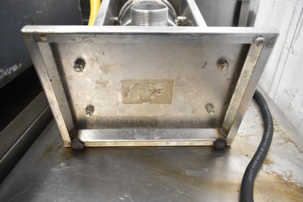 Uniworld countertop sausage stuffer base, stainless steel, with visible mounting bolts, moderate wear and some scratches.