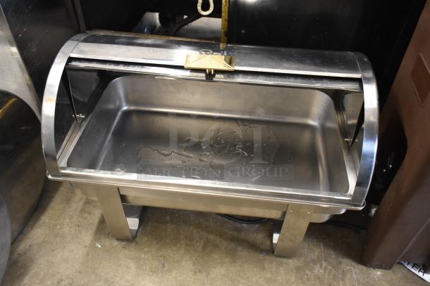 Stainless steel countertop roll top chafing dish with water droplets, includes two extra lids, in used condition.