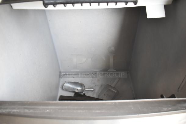 Manitowoc SY0854A commercial ice head on ice bin, 208-230V, 1 phase. Clean interior with metal scoop and plastic shovel.
