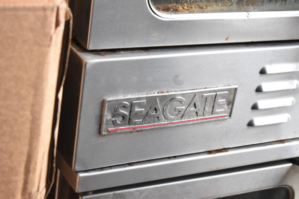 Seagate commercial convection oven with view-through window and thermostatic controls, featuring visible brand logo.