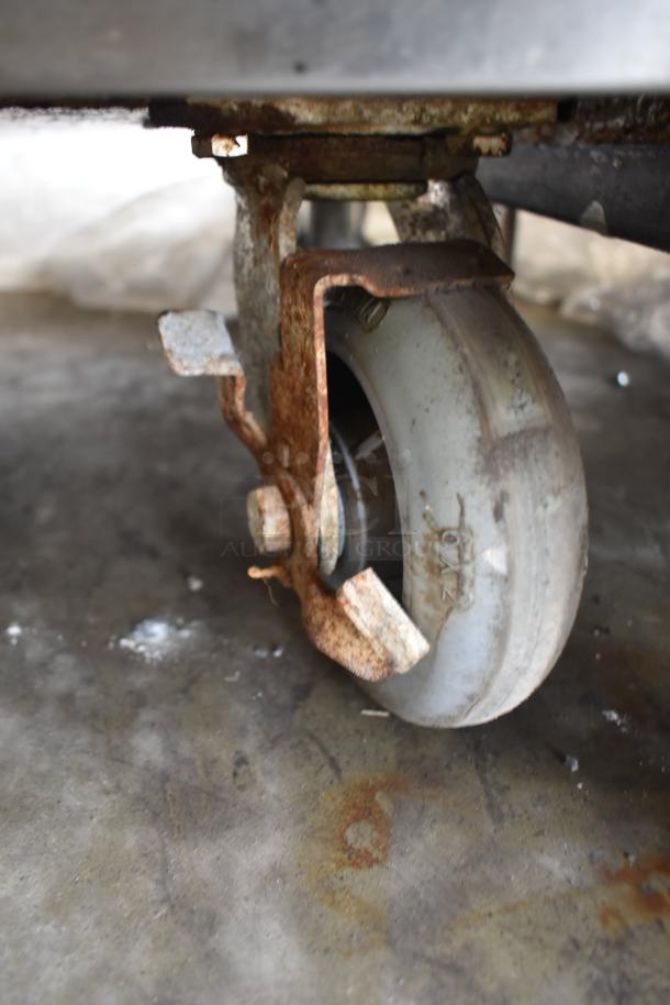 Rusted commercial caster wheel on a Seagate convection oven.