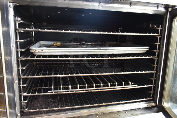 Seagate full-size convection oven interior with multiple racks, view-through door, on commercial casters, used condition.