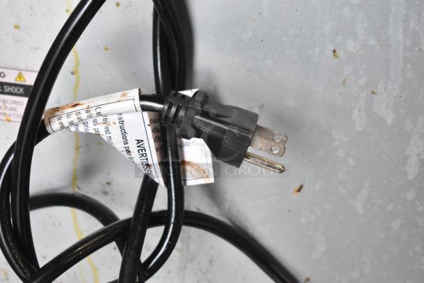 Power cord with warning label for Seagate convection oven; visible plug and instructions indicating electrical safety.