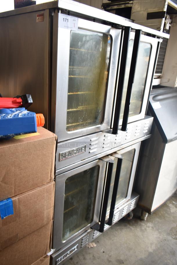 Two Seagate full-size convection ovens with view-through doors, thermostatic controls, on commercial casters.
