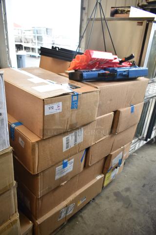 Boxes stacked in warehouse, labeled for auction with 23 various items, including Evolve LED Series area lights. Tags indicate lot number 172.