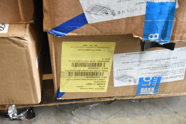 Boxes containing 23 mixed items, including Evolve LED Series area lights. Visible labels with shipping and product details.