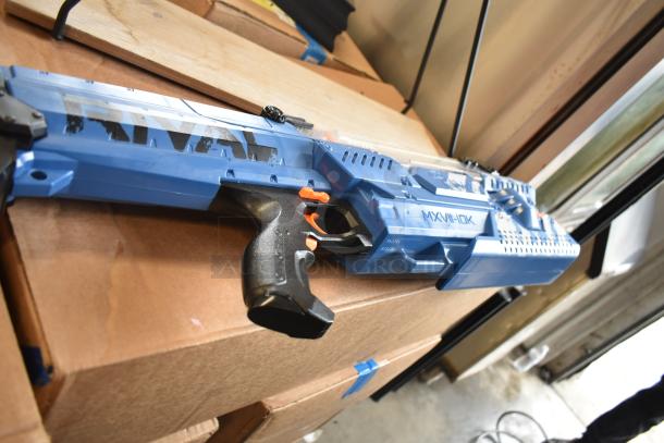 Blue Nerf Rival toy blaster on cardboard box, model MXV-IIOK. Marks suggest typical play wear.