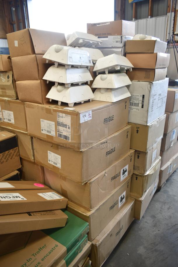Stacks of boxes with Dual Lite LED emergency lights and fragile labels, part of 47 various auction items.