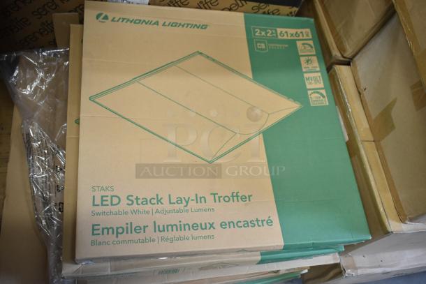 Eight new Lithonia Lighting CPXR Retrofit Kit boxes featuring LED Stack Lay-In Troffer, labeled switchable white and adjustable lumens.
