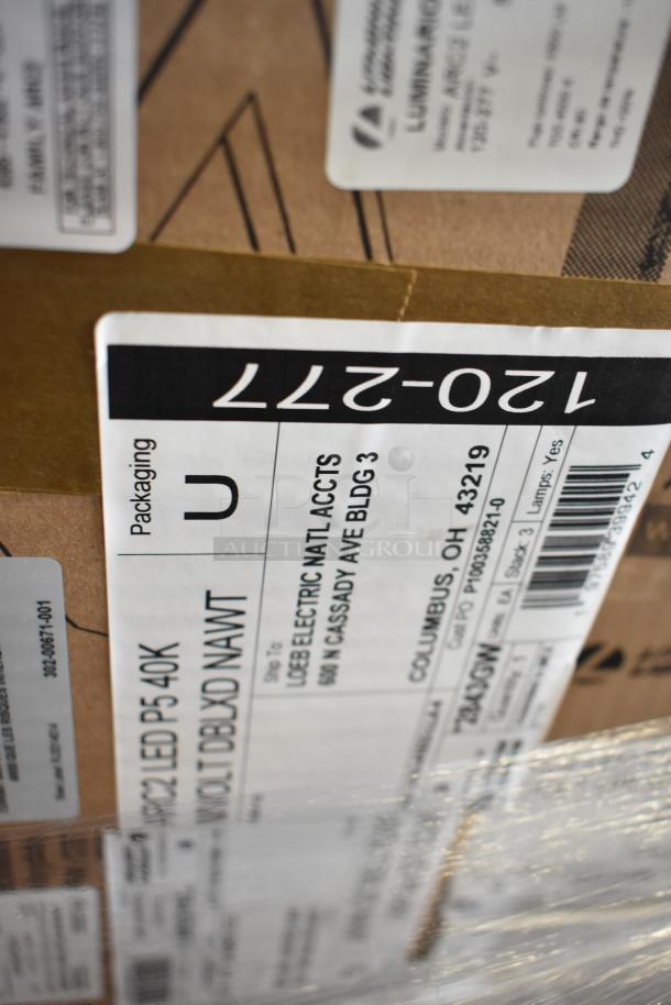 Box of Lithonia Lighting DSXF3 LED 6 P2 50K floodlights, brand-new with minor damage, packaging labels visible.