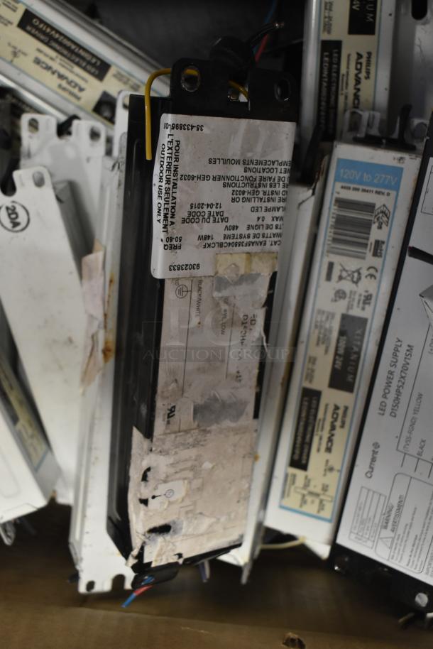 Lot of 180 ballasts including Philips Advance models, used condition, visible wiring and labels indicating outdoor use.