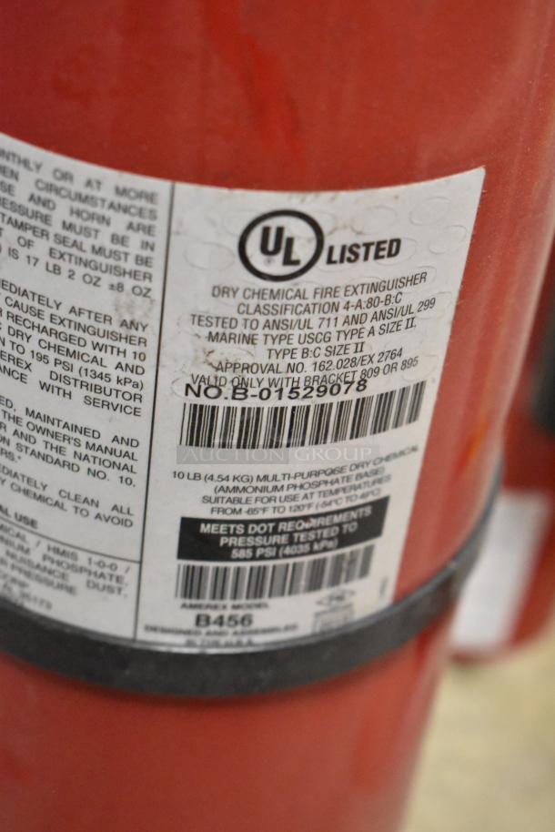 7 various fire extinguishers, UL listed, dry chemical, model B456, 10 lb capacity, label details pressure and standards.