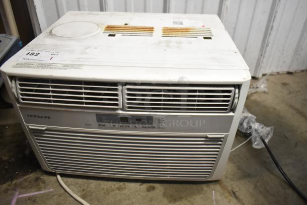 Frigidaire window mount air conditioning unit, 115 volts, 1 phase, visible wear on top, label with auction info, used condition.