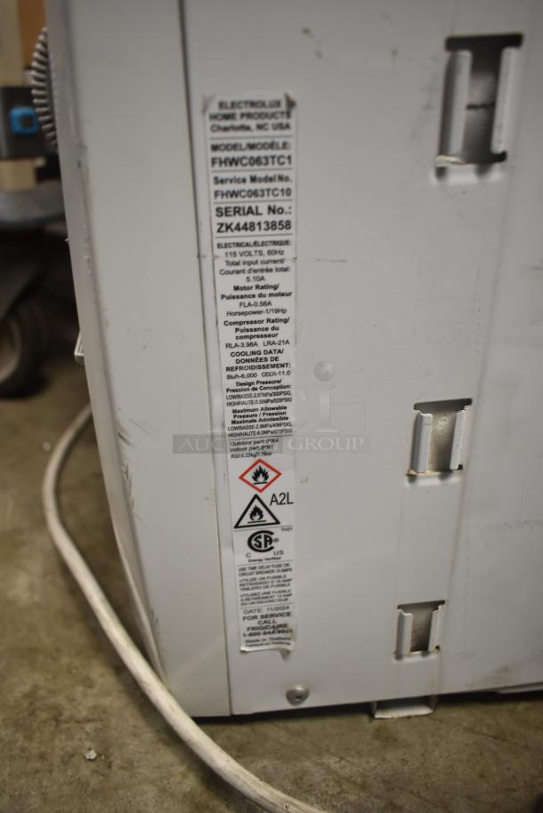 Frigidaire window mount AC unit. Model FHWC063TC1, 115 volts, 1 phase. Visible label with specifications and electrical info.
