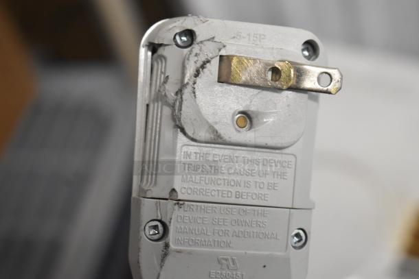 Frigidaire window air conditioning unit plug with visible 5-15P marking; shows usage wear and electrical safety instructions.