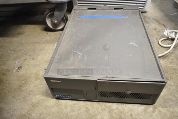Toshiba 4900-745 computer tower, used condition, metal casing, visible scratches, model label on front panel.