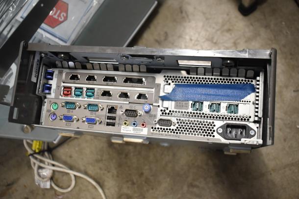 Back panel of Toshiba 4900-745 computer tower showing multiple ports and connections, labeled "Made in Malaysia."