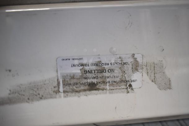 Four light fixtures with mounting instructions, slight wear and dirt visible. White label mentions "No Drilling" needed.