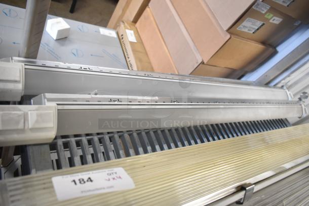 Set of four light fixtures, industrial style, metal construction. Includes visible auction tag "Lot 184 QTY 4X".