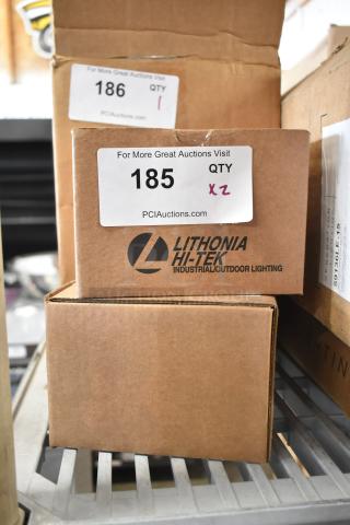 Two new Lithonia Lighting WSBBW DBLXD U Light boxes. Industrial outdoor lighting. Labels indicate auction lot numbers.