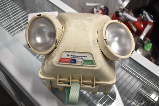 Lithonia Lighting emergency light with dual lamps, self-diagnostics panel, and test button, in used condition.