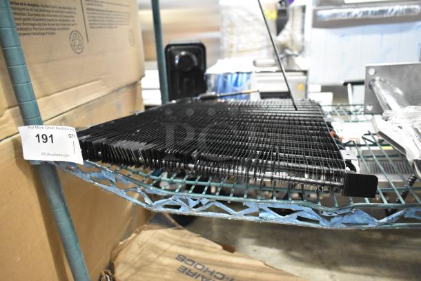 BRAND NEW Estella 34815657 evaporator coil for MCC220, scratch and dent condition, shown on metal shelving with auction tag.