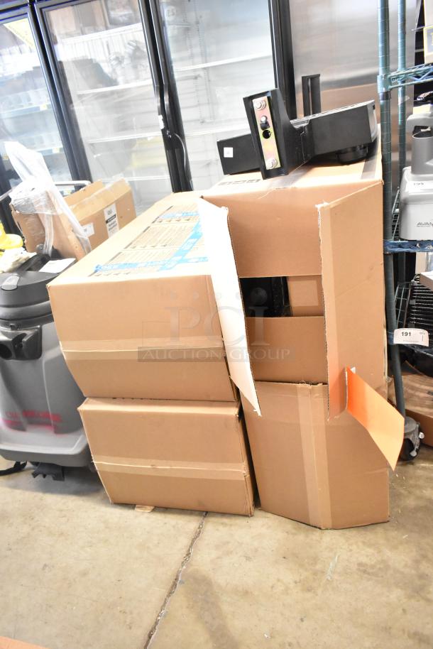 Four new Cooper Lighting fixtures, scratch and dent condition, boxed. Markings: "4 Times Your Bid" label visible.