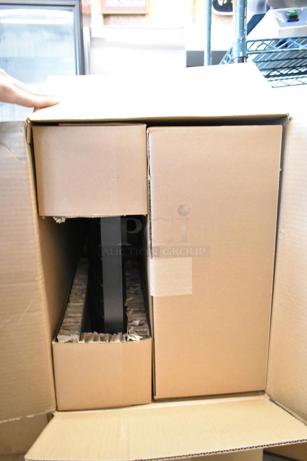 Cardboard box containing a Cooper Lighting light fixture, brand new with scratch and dent; packaging visible.