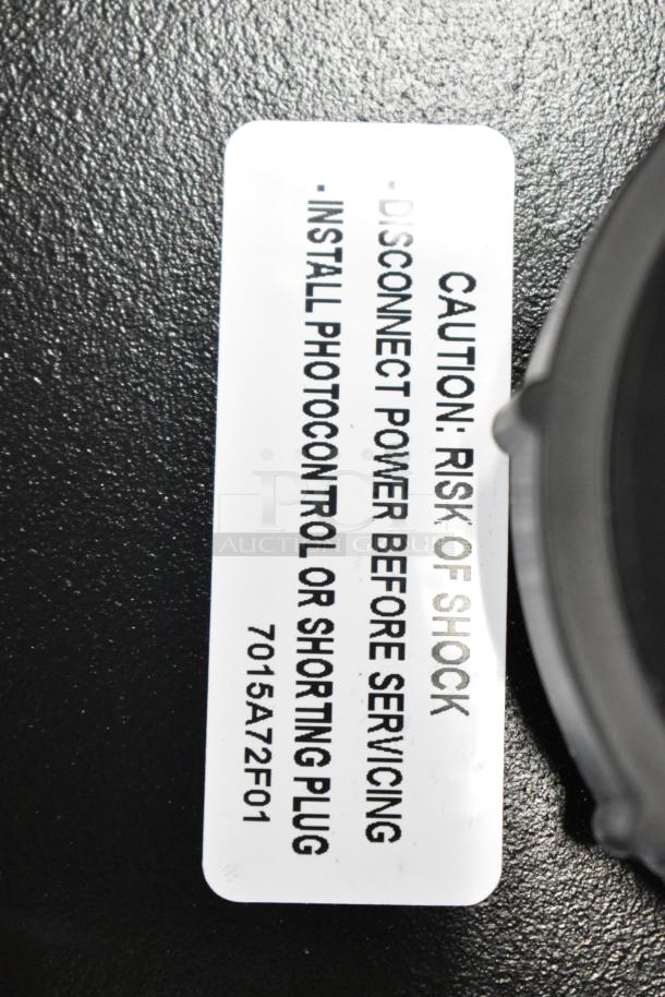 Cooper Lighting fixture, new condition, with caution label: "Risk of Shock. Disconnect Power Before Servicing. Install Photocontrol or Shorting Plug. 7015A72F01."