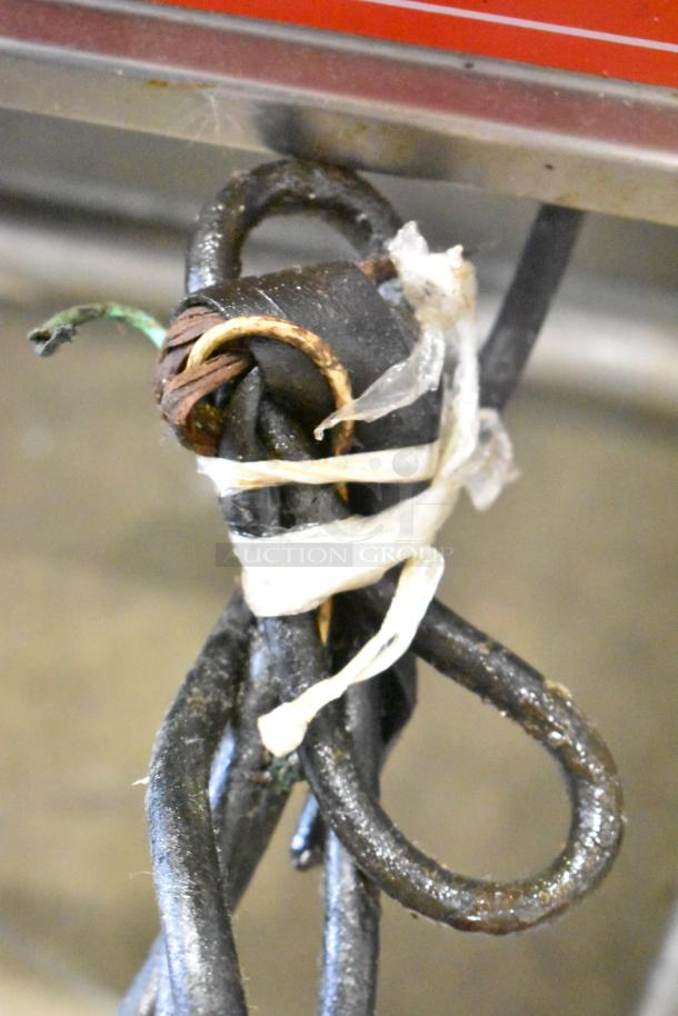 Damaged power cord of Vulcan Commercial Floor Style Braising Pan, showing frayed wires and makeshift plastic wrap binding.