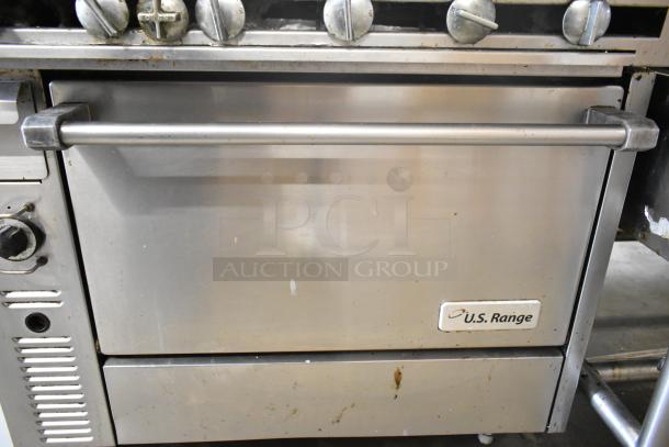 US Range commercial gas charbroiler grill with oven, stainless steel, visible wear, U.S. Range logo on front.