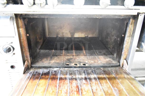 US Range Commercial Gas Charbroiler Grill with Oven, showing interior. Used condition, visible wear on surfaces.