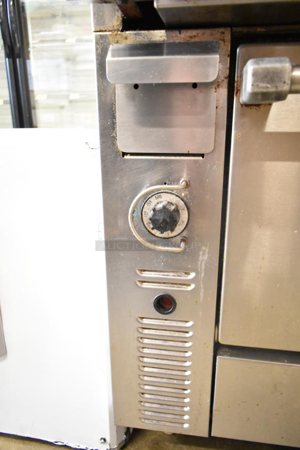 US Range commercial gas charbroiler grill with oven, stainless steel, features temperature dial, used condition.