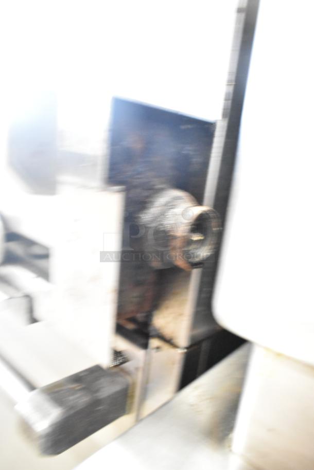 US Range commercial gas charbroiler grill with oven, featuring robust metal construction and visible rust spots.